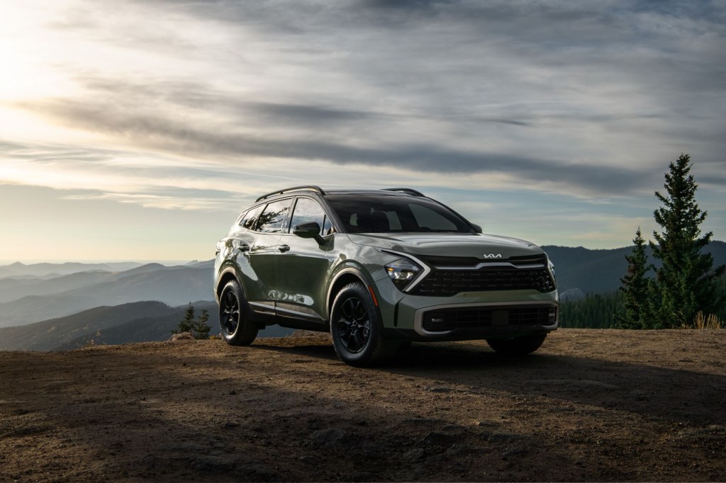 Green 2023 Kia Sportage with mountains in the background. Its X-Pro off-road trim enters the lineup for 2023.