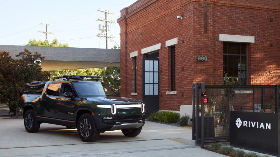 Green Rivian R1T parked next to the Venice Rivian Hub building