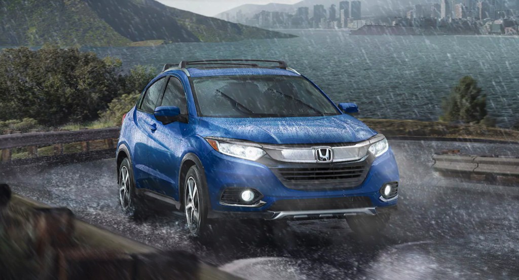 A blue Honda HR-V is parked in the rain.