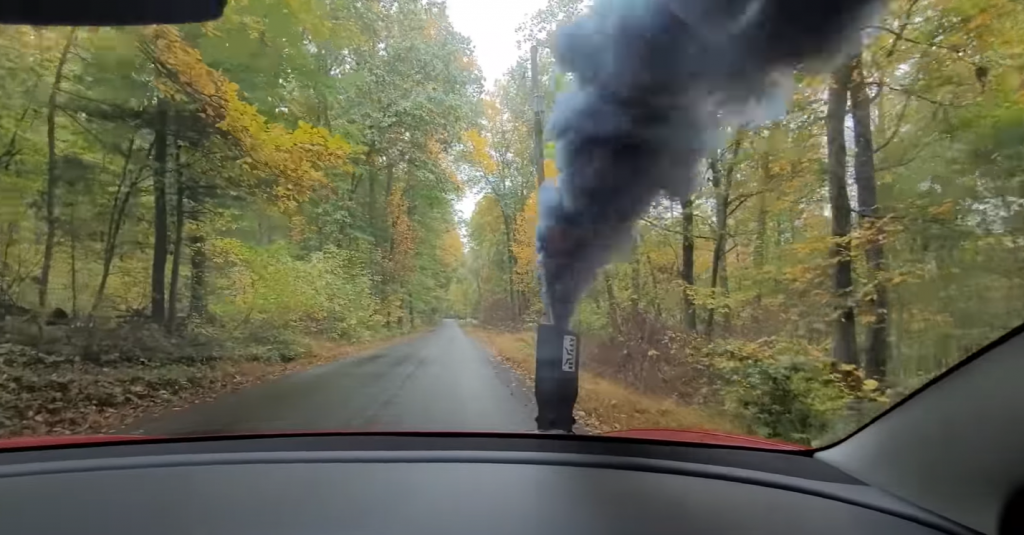 Hood stack on a Teslsa Model 3 rolling coal over the windshield