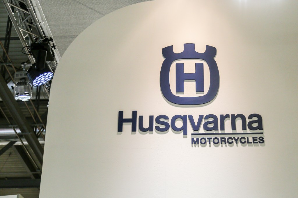 Husqvarna Motorcycles sign in blue on a white background.