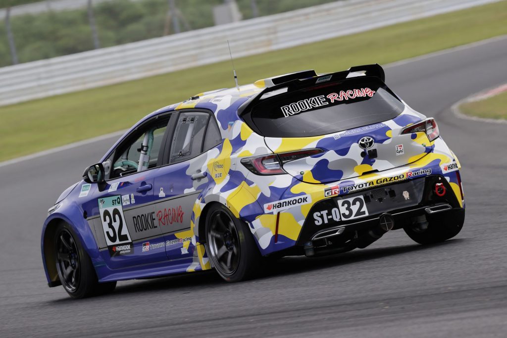 The rear 3/4 view of the hydrogen-combustion Toyota Corolla race car going around a racetrack