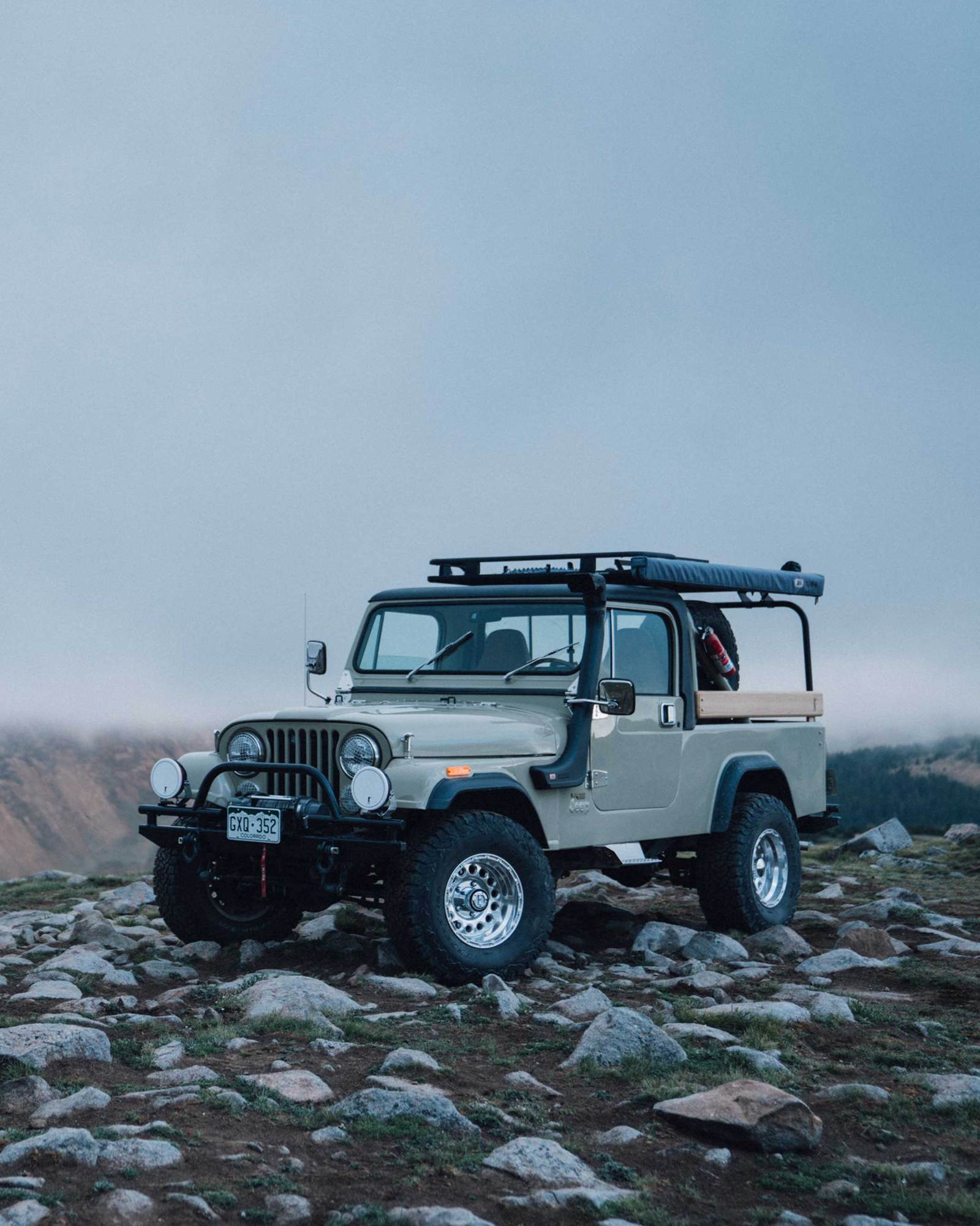 Ball and Buck's vintage Jeep CJ8 Scrambler on top of a mountain in the morning light