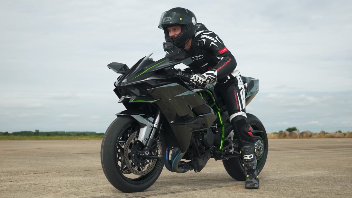 Kawasaki Ninja H2R racing sportbike with a rider sitting on it