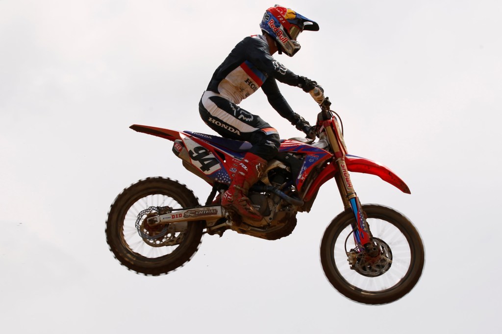 Ken Roczen jumps his Honda motocross bike through the air at the 2019 Red Bull Redbud National MX race