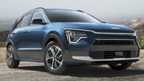 A blue Kia Niro Hybrid small hybrid SUV is parked.