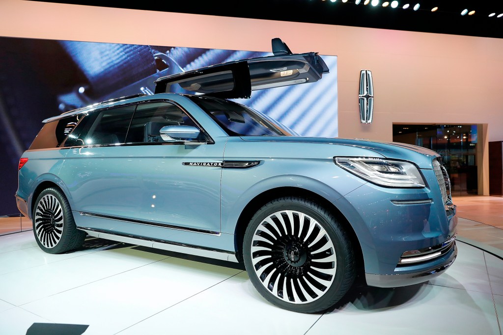 A blue Lincoln Navigator on display at an auto show 