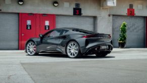 The Lotus Emira supercar parked in a strip of storage garages