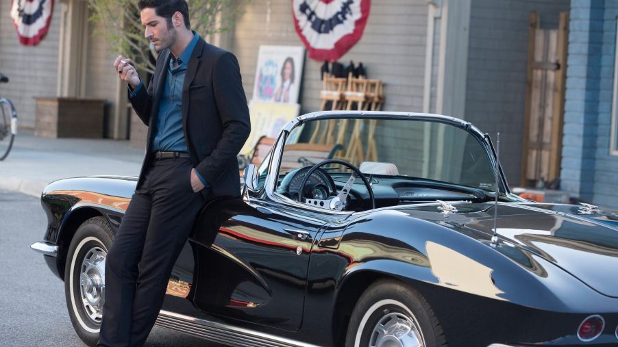 Lucifer standing next to his car.