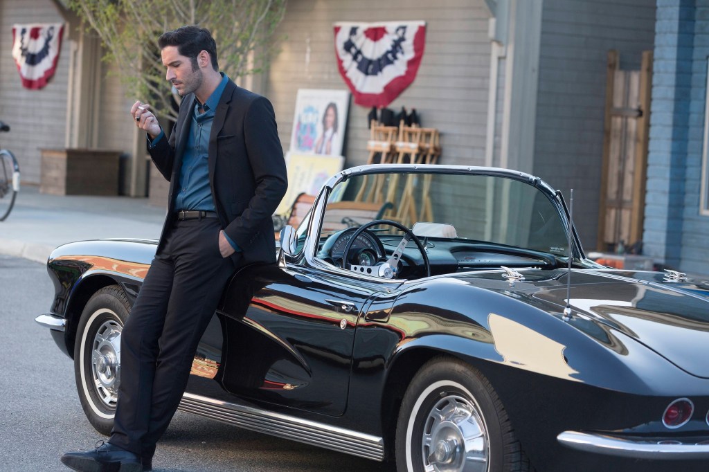 Lucifer standing next to his car.