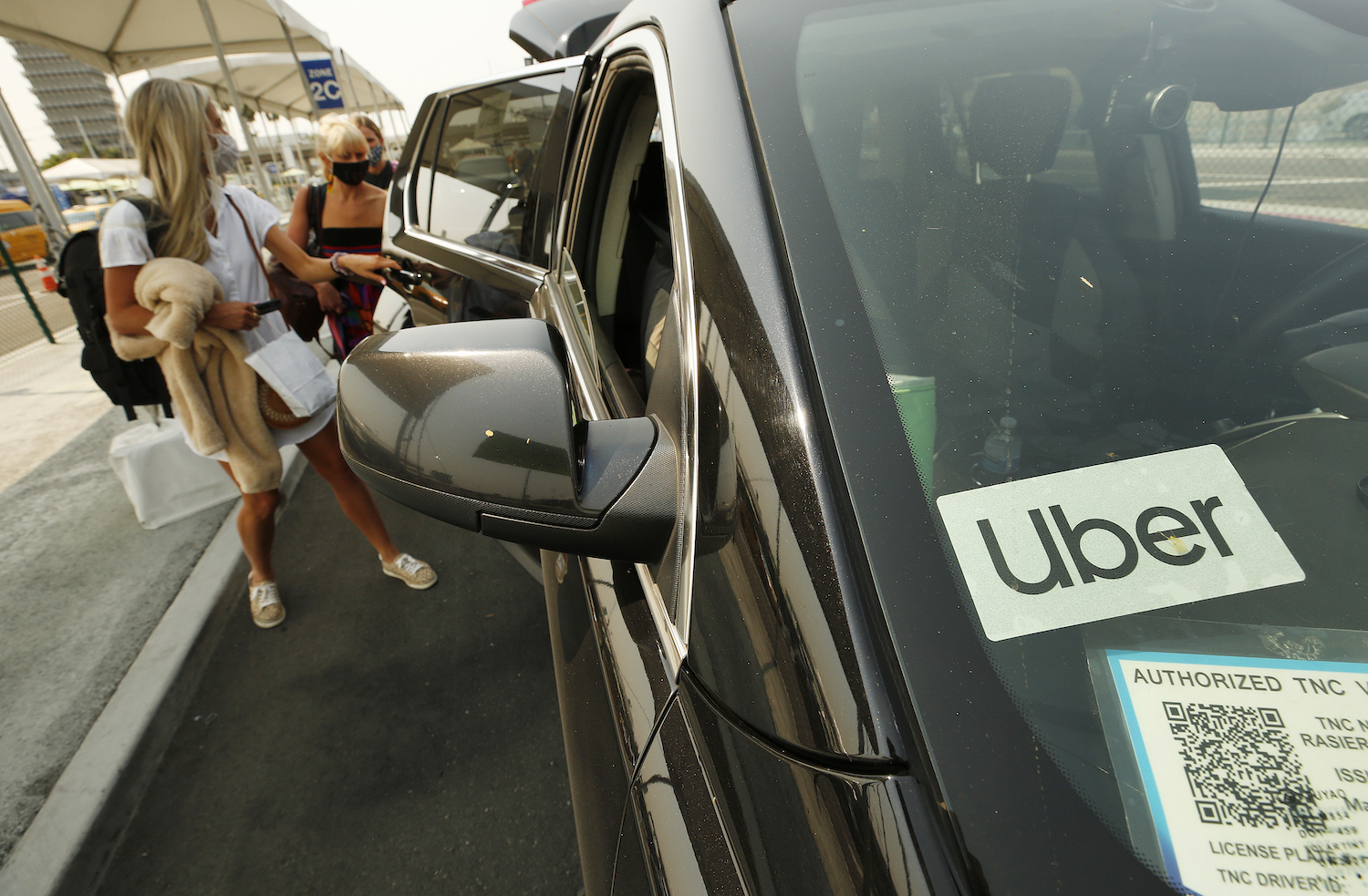 This is a photo of a passenger loading into an Uber rideshare. The Lyft and Uber safety teams have received thousands of reports of sexual assault in rideshares. | Al Seib /Los Angeles Times/Getty Images