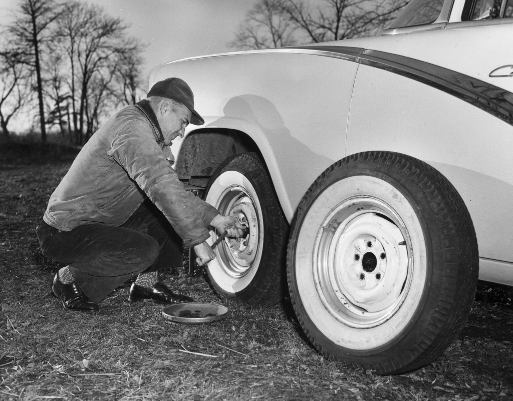Man Changing A Full-Sized Spare Tire