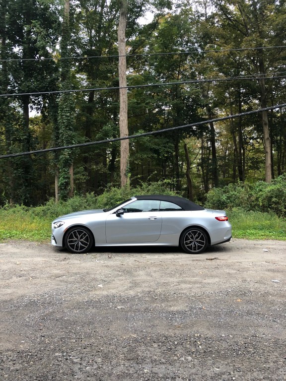 My silver 2021 Mercedes-Benz E450 review unit parked on the side of the road with the roof up