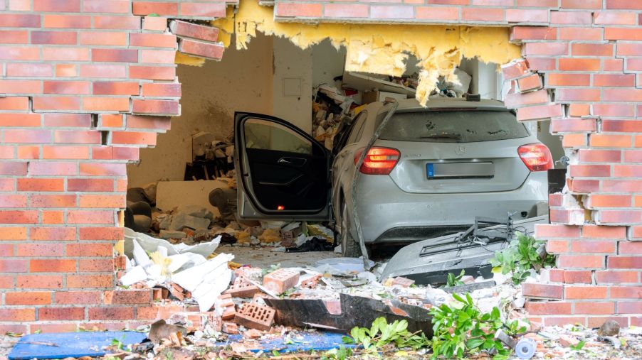 Mercedes-Benz car driven through the wall of an apartment building to show the need to insure a car