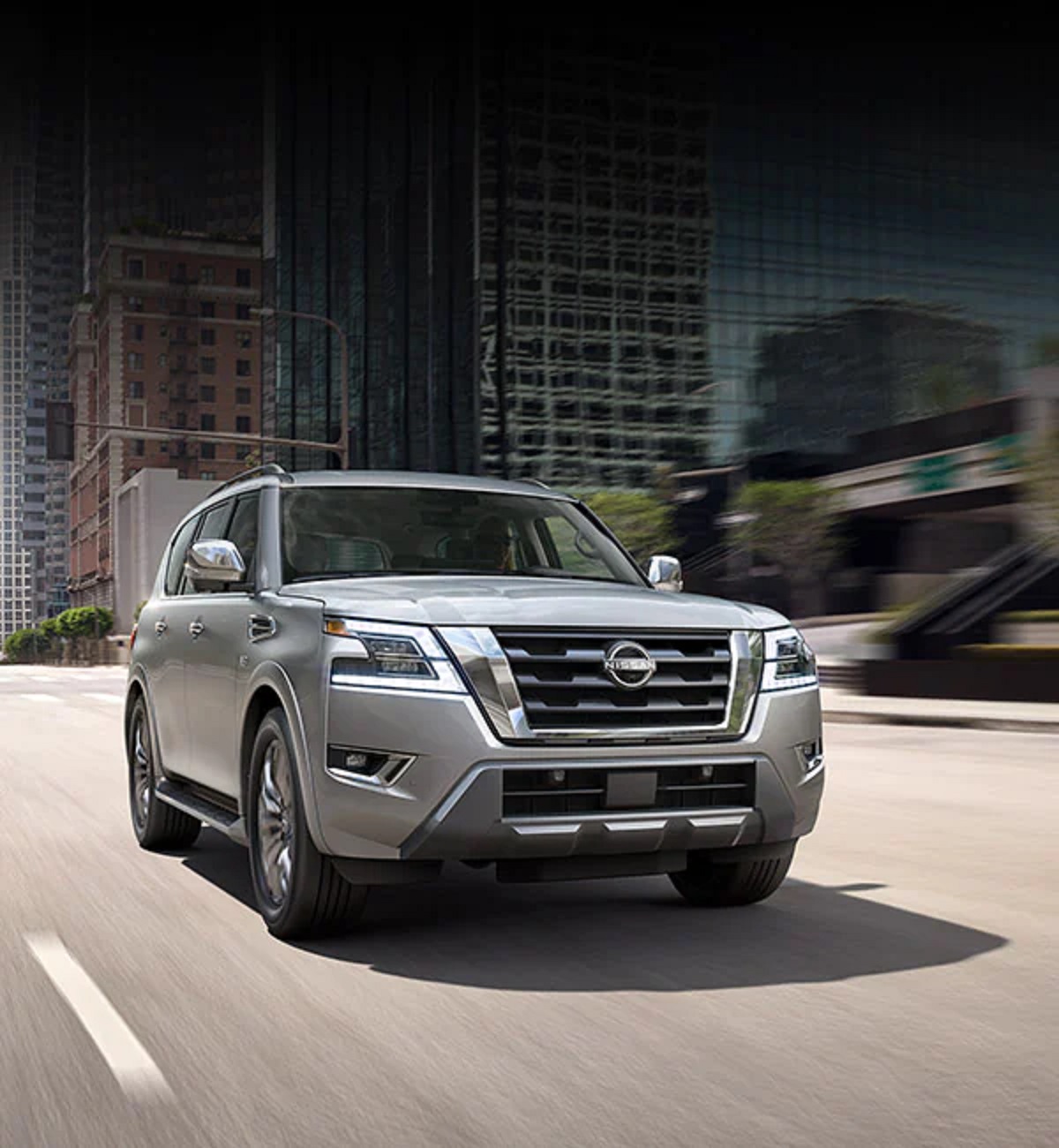 A silver 2021 Nissan Armada driving down a highway.