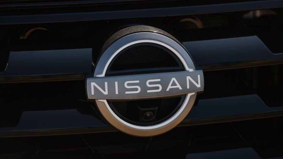 A chrome Nissan logo on a black grille.