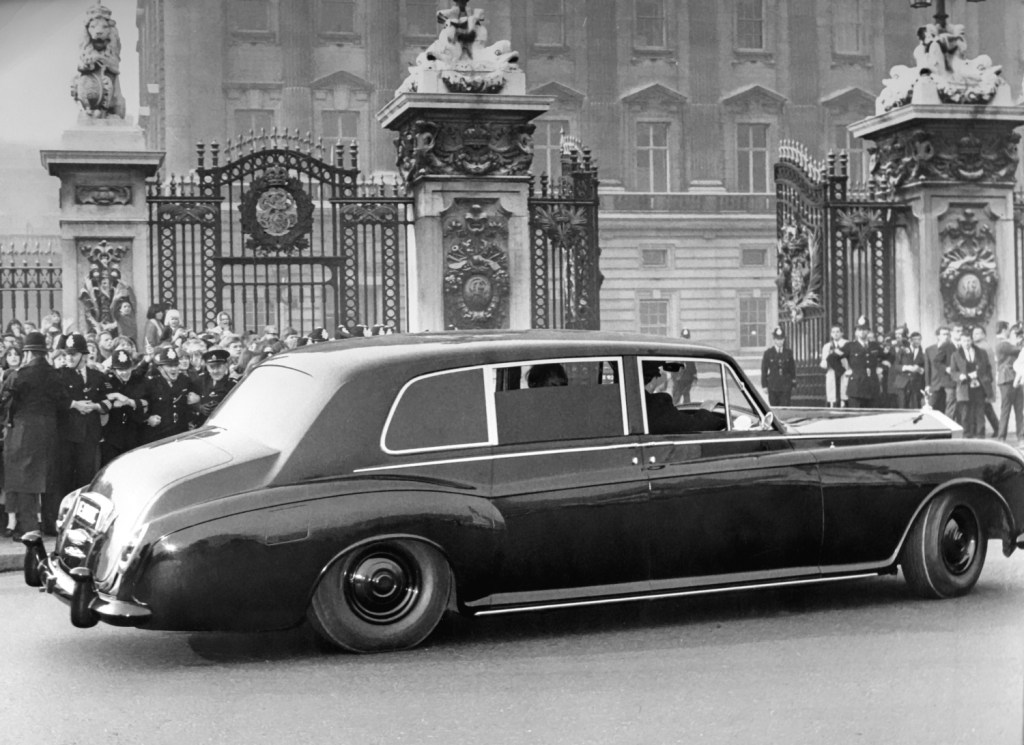 John Lennon's Rolls-Royce Phantom V approaches the gates of Buckingham Palace