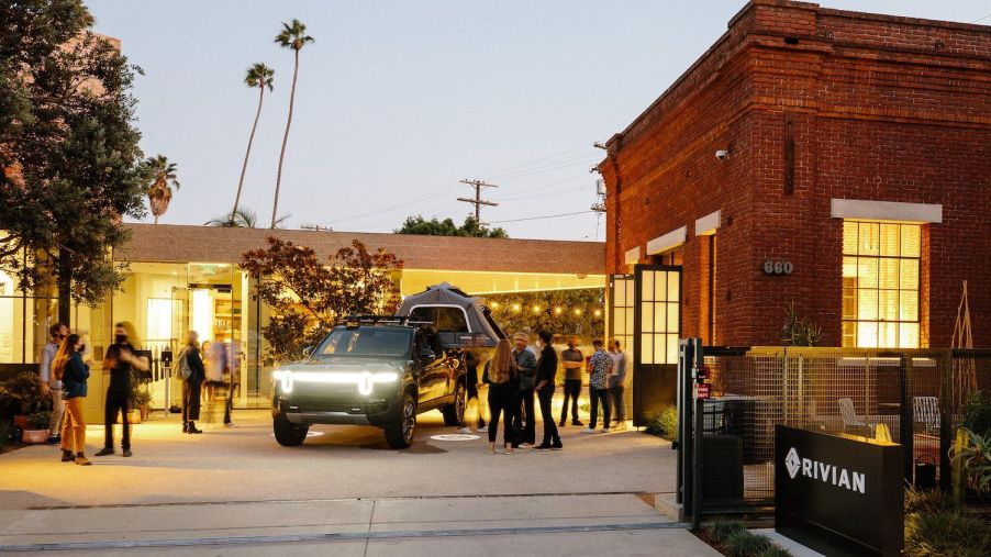 People having a party around a Rivian R1T at the Venice Rivian Hub