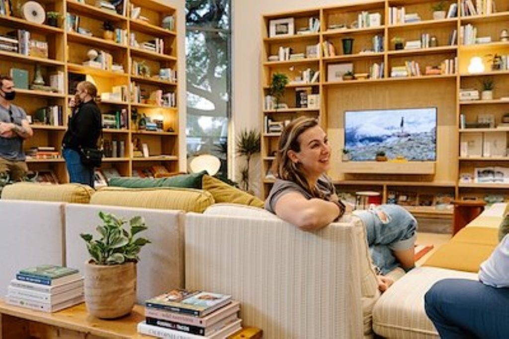 People relaxing in the library at the Venice Rivian Hub