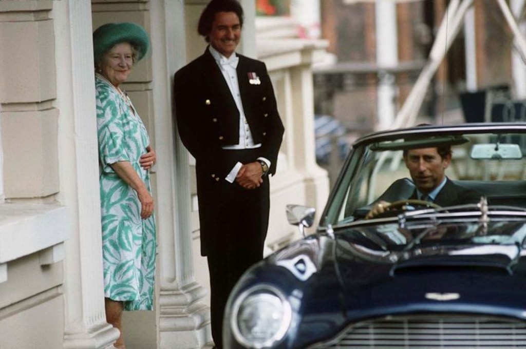 The Prince of Wales pulling away from the palace as the queen watches