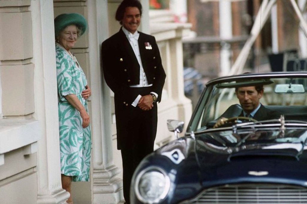 The Prince of Wales pulling away from the palace as the queen watches 