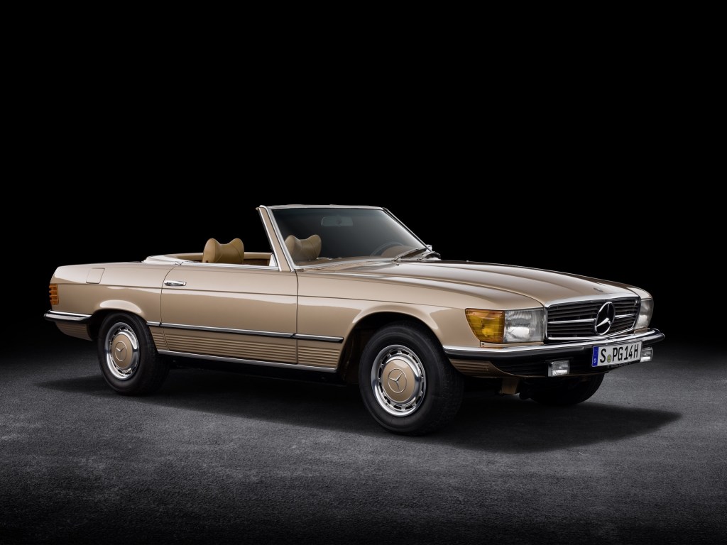 A beige R107 Mercedes 350 SL with its top down