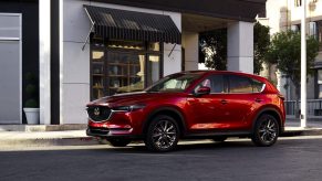 Red 2022 Mazda CX-5 parked near a white building