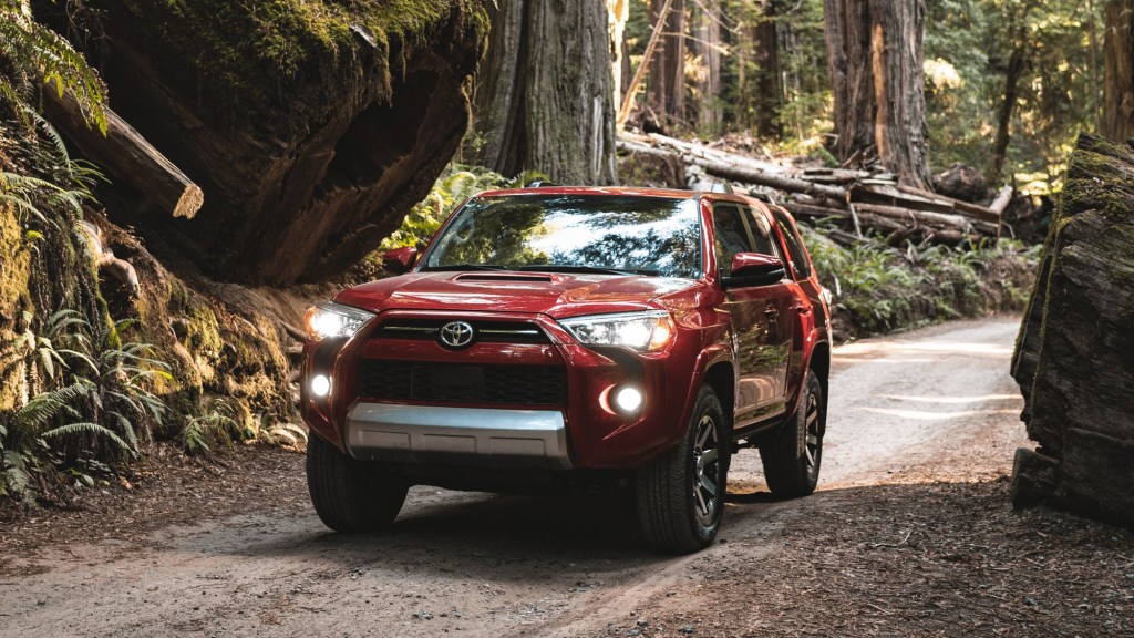 Red 2022 Toyota 4Runner driving through a forest