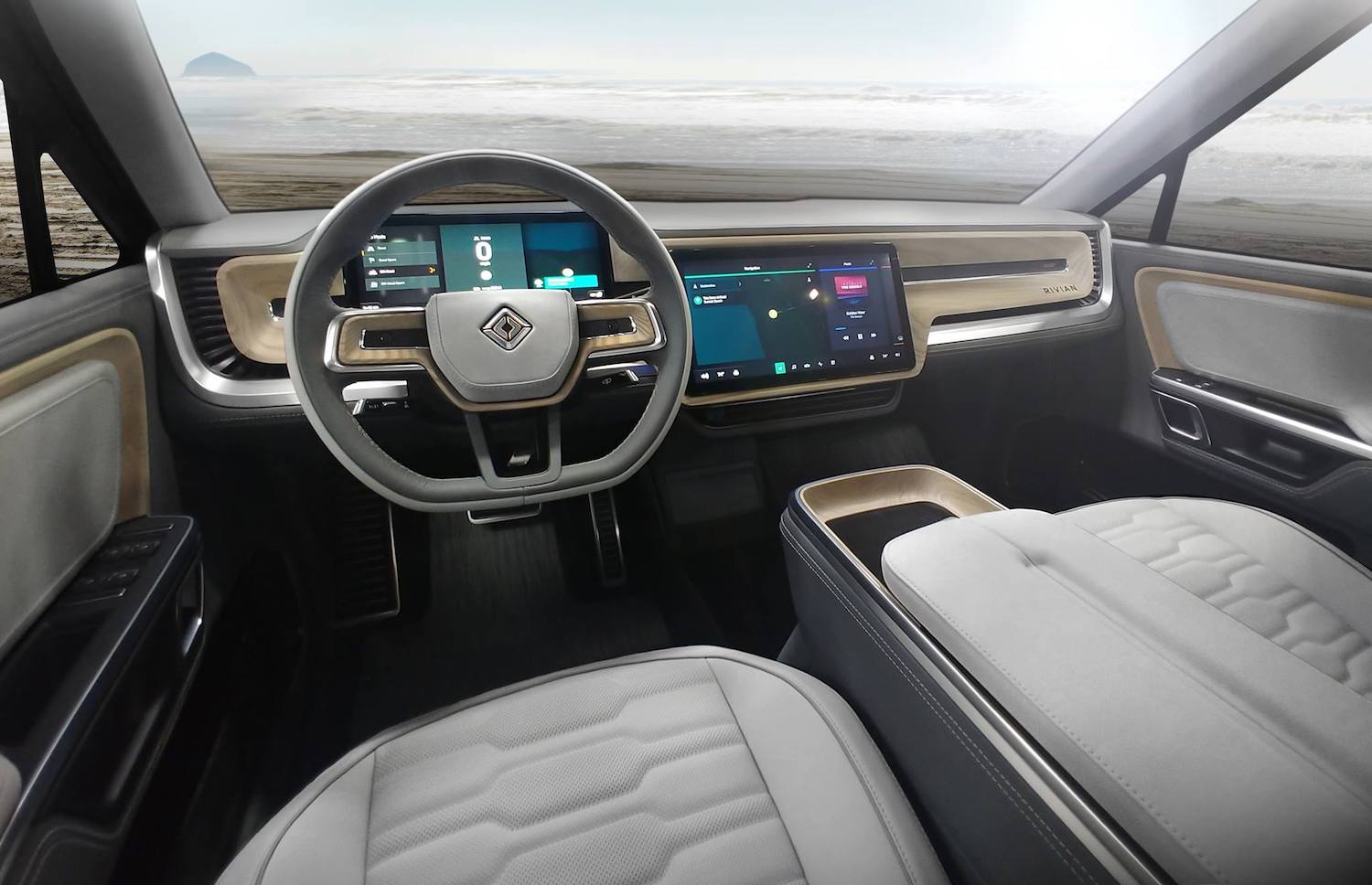 This is a promo photo of The Rivian Interior In The R1T Electric Pickup, parked by the ocean | Rivian