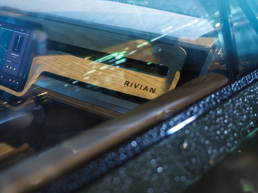 This is a promo photo of The Rivian Interior In The R1T Electric Pickup, in the rain | Rivian