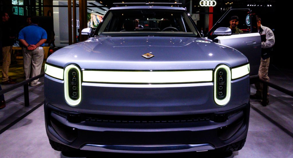 A gray Rivian R1T electric truck is on display. 