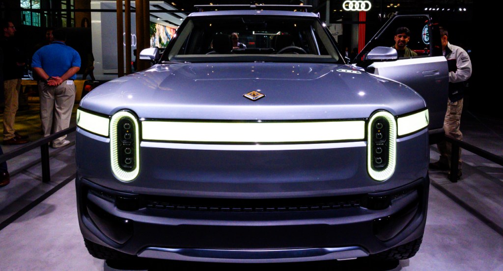 A gray Rivian R1T electric truck is on display.