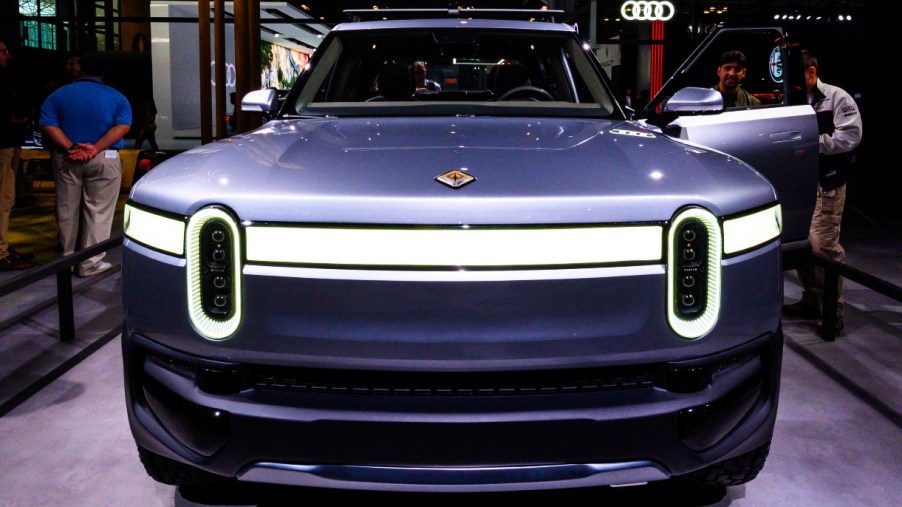A gray Rivian R1T electric truck is on display.
