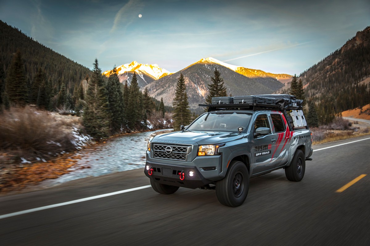 Nissan Project Overland Frontier truck driving along a mountain road. This truck will be on display at SEMA 2021