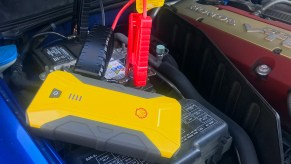 The Shell SH912 jump starter connected to a car battery