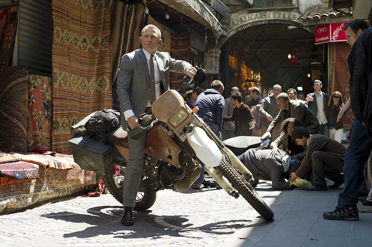 This is a still of Daniel Craig on a Honda CRF250R during Skyfall. Daniel Craig’s Stunt Double reveals the Secrets of the Iconic James Bond Motorcycle Chase in Skyfall. Bond will get back on a motorcycle to complete the No Time to Die motorcycle jump | MGM/Eon Productions/James Bond 007 Youtube Channel