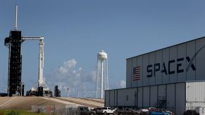 SpaceX building with launchpad in the background.