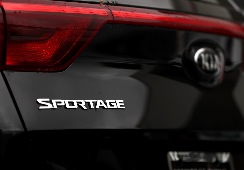 A black Kia Sportage close up on the Sportage name badge, there are some unreliable model years that should be avoided.