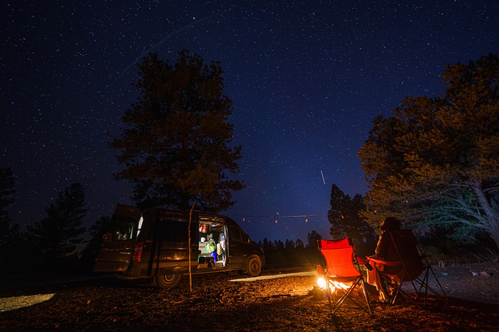 An extended exposure of a van lifer outside of a converted Sprinter camper van in the Kaibab National Forest on January 08, 2021, in Williams, Arizona.