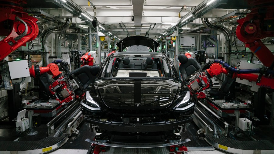 Tesla Model 3 sedan being assembled by robots. Tesla production was up to record levels in Q3 2021