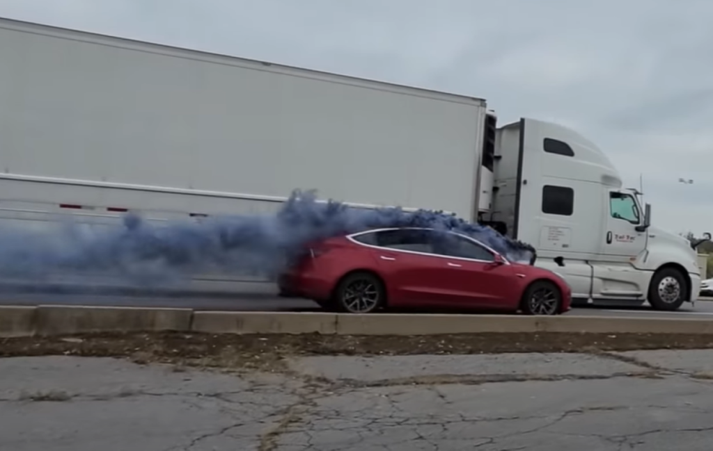 Tesla Model 3 rollling coal at a semi-truck