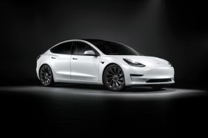 Tesla Model 3 in white during a showroom photo shoot