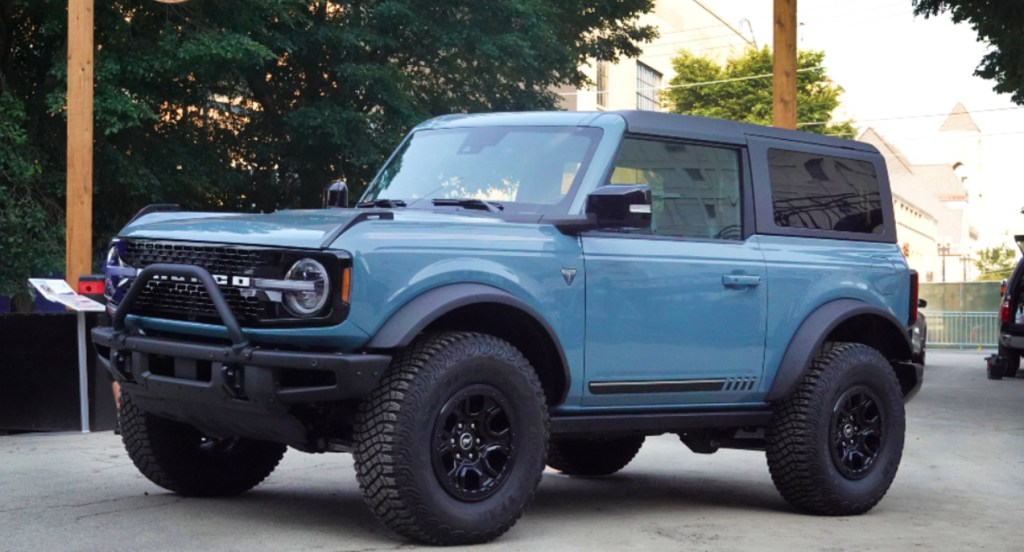 A blue Ford Bronco is on display.