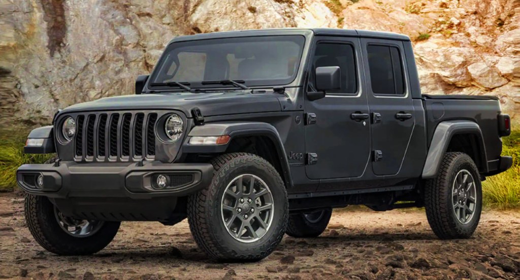 A black 2021 Jeep Wrangler is parked in a rocky area. 