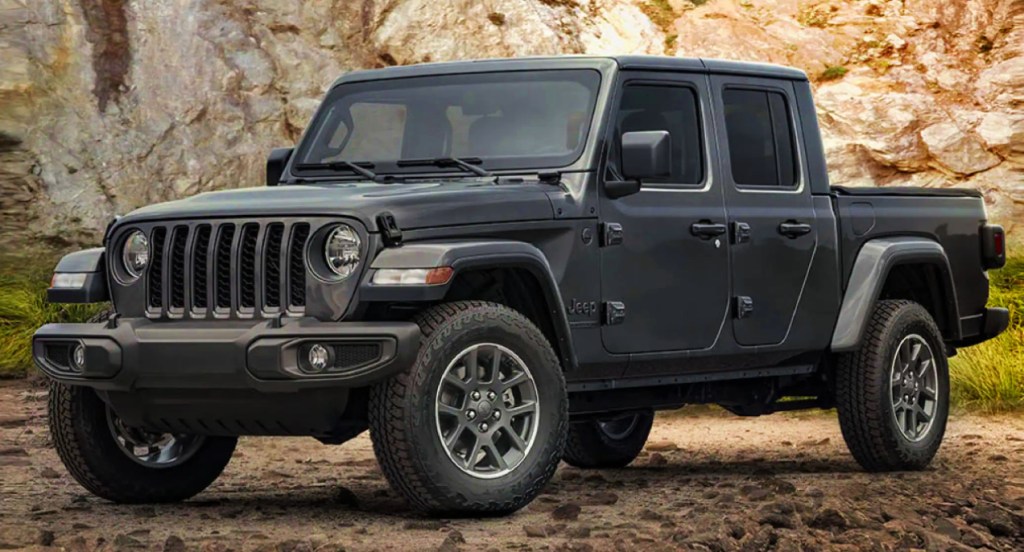 A black 2021 Jeep Wrangler is parked in a rocky area.