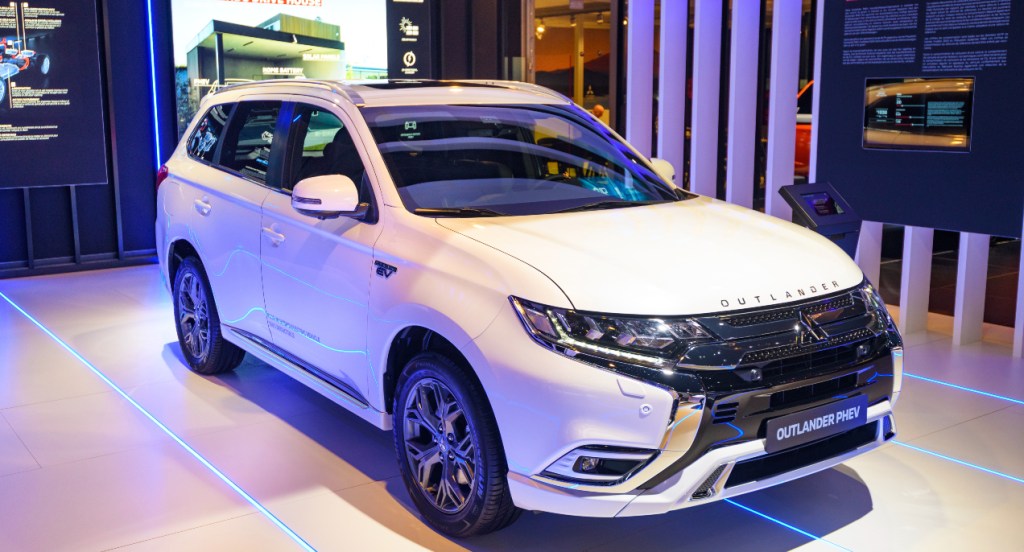 A white Mitsubishi Outlander is on display.