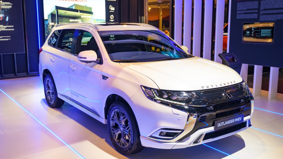 A white Mitsubishi Outlander is on display.