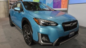 A blue Subaru Crosstrek is on display.
