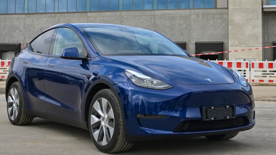 A Tesla Model Y in blue parked. A model just like this used Tesla's Sentry Mode to capture footage of an armed robbery