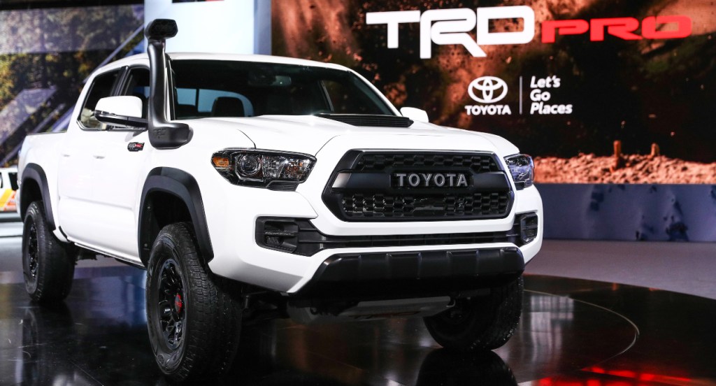 A white Toyota Tacoma TRD Pro is on display. 